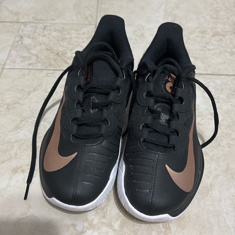 Black, copper strike, and white nikes